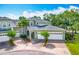 Charming townhome featuring a brick driveway, two-car garage, and well-maintained landscaping in a serene setting at 3852 Serenade Ln, Lakeland, FL 33811