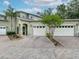Charming home exterior featuring a brick driveway, two-car garage, and well-manicured landscaping at 3852 Serenade Ln, Lakeland, FL 33811