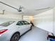Clean, well-lit garage featuring ample space for parking and storage, with stairs leading up at 3852 Serenade Ln, Lakeland, FL 33811