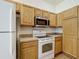 Practical kitchen with a stainless steel microwave, ample counter space, and wood cabinets at 3852 Serenade Ln, Lakeland, FL 33811