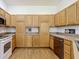 Efficient kitchen with stainless steel dishwasher, wood cabinetry, and durable countertops at 3852 Serenade Ln, Lakeland, FL 33811