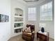Comfortable sitting area with leather recliner, built-in shelving, and natural light from nearby windows at 3852 Serenade Ln, Lakeland, FL 33811