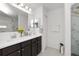 Modern bathroom boasts double sinks, sleek dark wood cabinets, and a glass enclosed shower at 3857 Hampstead Ln, Lakeland, FL 33810