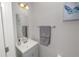 Cozy half bathroom featuring a vessel sink, decorative mirror, and gray accent towels at 3857 Hampstead Ln, Lakeland, FL 33810