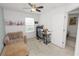 Bright bedroom includes an accent chair, ceiling fan, and workspace area by a window at 3857 Hampstead Ln, Lakeland, FL 33810