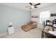 Inviting bedroom with a plush armchair, office desk, and soft carpet flooring at 3857 Hampstead Ln, Lakeland, FL 33810