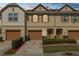 Charming townhome with a well-maintained lawn, a one-car garage, and a welcoming entrance at 3857 Hampstead Ln, Lakeland, FL 33810