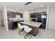 Well-lit kitchen showcasing stainless steel appliances, granite countertops, and a convenient island with seating at 3857 Hampstead Ln, Lakeland, FL 33810