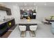Bright kitchen boasting granite countertops, dark cabinetry, and a functional center island with bar stools at 3857 Hampstead Ln, Lakeland, FL 33810