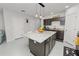 Spacious kitchen with granite countertops, dark cabinets, and a large island with seating at 3857 Hampstead Ln, Lakeland, FL 33810