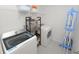 Laundry room with a front-loading washer, dryer, and shelving at 3857 Hampstead Ln, Lakeland, FL 33810