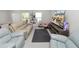 Open-concept living area featuring ample seating, natural light, and seamless access to the dining area at 3857 Hampstead Ln, Lakeland, FL 33810
