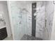 Contemporary shower design featuring marble and gray tiling with a built-in niche at 3857 Hampstead Ln, Lakeland, FL 33810