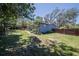 Expansive backyard with lush lawn, mature trees, and a well-maintained home exterior at 3880 Cleveland Heights Blvd, Lakeland, FL 33813