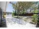 Backyard features concrete patio, mature landscaping, and a yellow door at 3880 Cleveland Heights Blvd, Lakeland, FL 33813