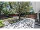 Lush backyard featuring a pergola, concrete patio, mature trees and full fencing at 3880 Cleveland Heights Blvd, Lakeland, FL 33813