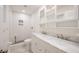 Modern bathroom with dual sinks, white cabinets, and a tiled walk-in shower at 3880 Cleveland Heights Blvd, Lakeland, FL 33813