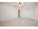 Spacious bedroom with speckled flooring, ceiling fan, and access to an ensuite bathroom and closet at 3880 Cleveland Heights Blvd, Lakeland, FL 33813