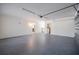 Large garage space with painted floors, bright lighting, and secure access gate to laundry area at 3880 Cleveland Heights Blvd, Lakeland, FL 33813
