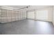 Spacious two car garage featuring a light gray painted floor and cinder block ventilation at 3880 Cleveland Heights Blvd, Lakeland, FL 33813