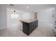Open floor plan with a view of the kitchen island, stainless steel appliances, and spacious living area at 3880 Cleveland Heights Blvd, Lakeland, FL 33813