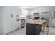 Modern kitchen with stainless steel appliances, a central island, white cabinetry, and modern decor at 3880 Cleveland Heights Blvd, Lakeland, FL 33813