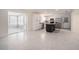 Bright open kitchen and sunroom space, featuring stainless steel appliances and updated fixtures at 3880 Cleveland Heights Blvd, Lakeland, FL 33813