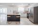 Bright, modern kitchen with stainless steel appliances, white cabinets, and center island with seating at 3880 Cleveland Heights Blvd, Lakeland, FL 33813