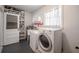 Bright laundry room with newer washer and dryer, wash sink, and shelving at 3880 Cleveland Heights Blvd, Lakeland, FL 33813