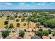 An aerial shot displays the home's position near green spaces, offering a serene and natural environment at 3942 Warbler Dr, Winter Haven, FL 33880
