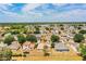 An aerial view of the home highlighting its location within a well-established neighborhood with green spaces and mature trees at 3942 Warbler Dr, Winter Haven, FL 33880