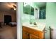 This bathroom features a wooden vanity and a large mirror above it at 3942 Warbler Dr, Winter Haven, FL 33880