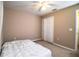 This bedroom features carpet floors, a ceiling fan, and a closet for storage at 3942 Warbler Dr, Winter Haven, FL 33880