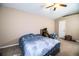 This bedroom features carpet floors, a ceiling fan, and a large window for natural light at 3942 Warbler Dr, Winter Haven, FL 33880