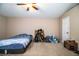 This bedroom features carpet floors, a ceiling fan, and a large window for natural light at 3942 Warbler Dr, Winter Haven, FL 33880