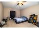 This bedroom features carpet floors, a ceiling fan, and a large window for natural light at 3942 Warbler Dr, Winter Haven, FL 33880