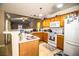 Bright kitchen features wood cabinets, a white refrigerator, and an open layout with a breakfast bar at 3942 Warbler Dr, Winter Haven, FL 33880