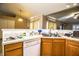 Kitchen features a stainless steel sink, white appliances and wood cabinets at 3942 Warbler Dr, Winter Haven, FL 33880
