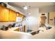 Well-lit kitchen boasts a breakfast bar, wood cabinetry and modern appliances, including a microwave and dishwasher at 3942 Warbler Dr, Winter Haven, FL 33880