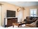 The cozy living room features a mounted deer head, shutters, and is furnished with comfortable seating and a TV console at 3942 Warbler Dr, Winter Haven, FL 33880