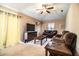 The open-concept living room has plush seating, a mounted deer head, and large windows for natural light at 3942 Warbler Dr, Winter Haven, FL 33880