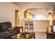 Cozy living room with modern decor and a view into the kitchen and dining area at 3942 Warbler Dr, Winter Haven, FL 33880