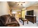 Spacious living room with comfortable seating, modern entertainment center, and open view to the kitchen at 3942 Warbler Dr, Winter Haven, FL 33880