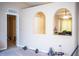 Bright open-concept living room featuring arched entryways and neutral paint at 3942 Warbler Dr, Winter Haven, FL 33880