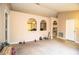 Open living area with arched openings to other rooms and neutral carpeting at 3942 Warbler Dr, Winter Haven, FL 33880