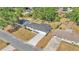 Aerial view of a newly renovated home with a long driveway, nestled amongst lush trees and well-maintained lawns at 4028 S Wellington Dr, Lakeland, FL 33813