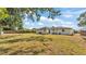 Large, grassy backyard featuring a spacious patio, perfect for outdoor gatherings and relaxation at 4028 S Wellington Dr, Lakeland, FL 33813