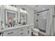 Bathroom featuring a double vanity sink, sleek fixtures, and walk-in shower at 4028 S Wellington Dr, Lakeland, FL 33813