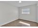 Bright bedroom featuring a window, hardwood floors, and fresh paint at 4028 S Wellington Dr, Lakeland, FL 33813