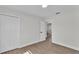 Bright bedroom with closet, sleek flooring, and a glimpse into the entryway at 4028 S Wellington Dr, Lakeland, FL 33813